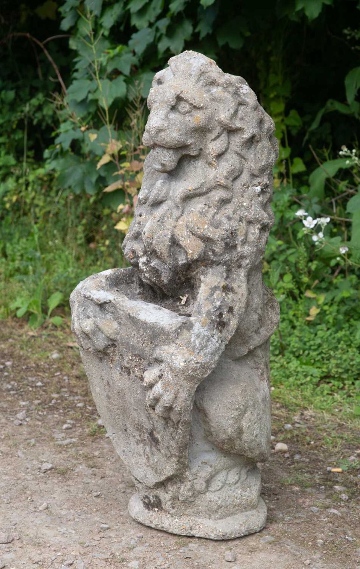 An old cast reconstituted stone lion supporting a shield, 28cm wide x 88cm highSome minor signs of - Image 2 of 4