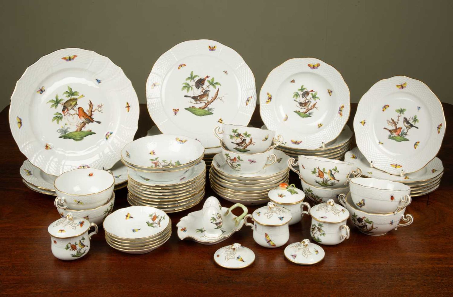 A Hungarian Herend porcelain part dinner service decorated with birds and butterflies and with a