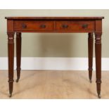A George III mahogany side table with twin frieze drawers and tapering reeded legs terminating in