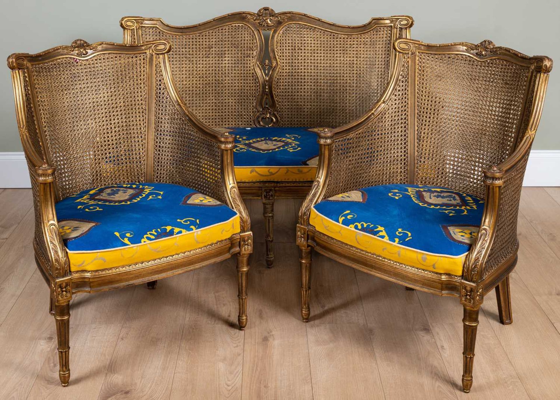 A 20th century gilt Berger suite consisting of a two seater sofa and two chairs, all with double