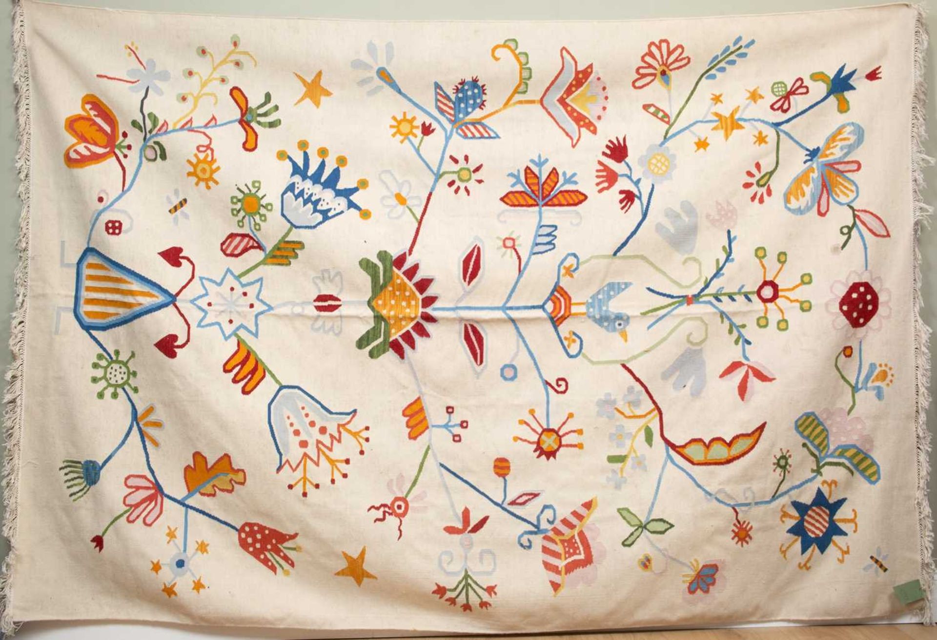 A modern white ground Kelim rug decorated with flowers, a bird and insects, 314cm x 207cm Minor