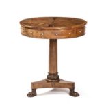 A William IV style walnut drum table of small proportions, having four drawers and four faux drawers