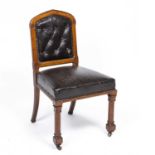 A Victorian Gothic revival oak side chair with leatherette upholstery, carved octagonal front legs