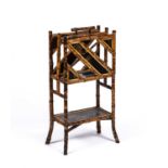 A 19th century bamboo magazine rack with inset Japanese lacquered panels, 45cm wide x 27cm deep x