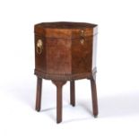 A George III mahogany cellarette of octagonal form, with brass lion ring handles, square legs and