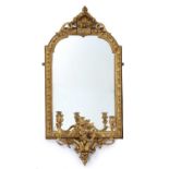 A Georgian gilded gesso framed girandole mirror with neoclassical scrolling decoration, 54cm wide