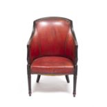 A 19th century mahogany framed tub chair with studded red leather upholstery, turned and reeded