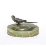 An early 20th century Austrian cold painted bronze budgerigar mounted on an onyx tray, the budgie