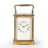 A 19th century French brass carriage clock the white enamelled dial with roman numerals, oval