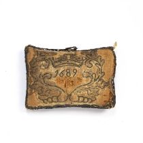 A 17th century pin cushion, dated 1689 and initialled AB, having a straw filling and embroidered