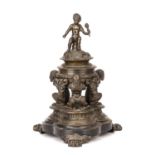 A 19th century Grand Tour bronze Inkwell with a cherub finial with three faun supports. 20cm wide