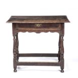 An 18th century oak side table with a single frieze drawer and turned supports united by stretchers,