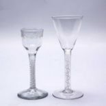 A mid to late 18th century English wine glass with an ogee engraved bowl, an opaque white twist stem