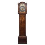 An 18th century eight day walnut longcase clock, the 12" break arch brass dial with silvered Roman