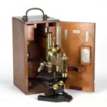 A late 19th century Ernst Leitz Weltzar Brass Microscope No 106109 with four lenses in a fitted