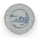 An 18th century Bristol Delft plate having a wavy border and painted with Eastern scenes, 22cm