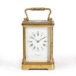 A French gilt brass carriage timepiece, the white enamel Roman dial with Arabic five minutes,