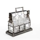 A Victorian silver plated three bottled tantalus marked 'The Tantalus', 33.5cm wide x 15cm deep x