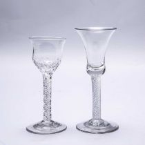 A mid to late 18th century English wine glass with a bell bowl, an air twist stem and a plain