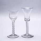 A mid to late 18th century English wine glass with a bell bowl, an air twist stem and a plain