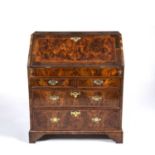 George I burr walnut veneered bureau, the fall front opening to reveal short drawers and pigeon
