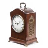 An Edwardian mahogany bracket or table clock with convex white Roman dial, the twin chain fusee
