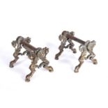 A pair of late 18th / early 19th century gilt bronze fire dogs of acanthus leaf and claw and ball