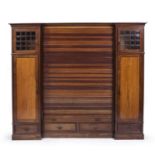 A late 19th century mahogany bookcase cabinet, the central bookcase with five shelves having a