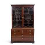 A George III mahogany library bookcase, with twin astral glazed door above a caddy top with a