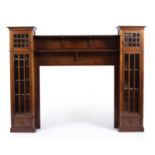 A late 19th century mahogany cabinet or desk surround on a central mantle piece flanked by