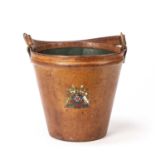 A Victorian leather fire bucket with a leather handle on brass rings and a transfer printed coat
