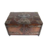 A 17th century German oak and metal bound table top cabinet of drawers, having a double headed eagle