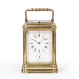 A 19th century French brass carriage clock, the white enamel Roman dial with Arabic five minutes and