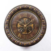 A late 19th century oak dial clock with applied brass Roman chapters, leaf carved and polychrome