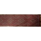 Anatolian runner of red ground with small diamond medallions, and foliate designs, 484cm x 111cm (