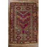 Kirshehir prayer rug Turkish, 19th Century decorated in red and gold ground with various symbols,