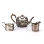 Matched three-piece silver tea set each piece with different marks, some of which are rubbed and