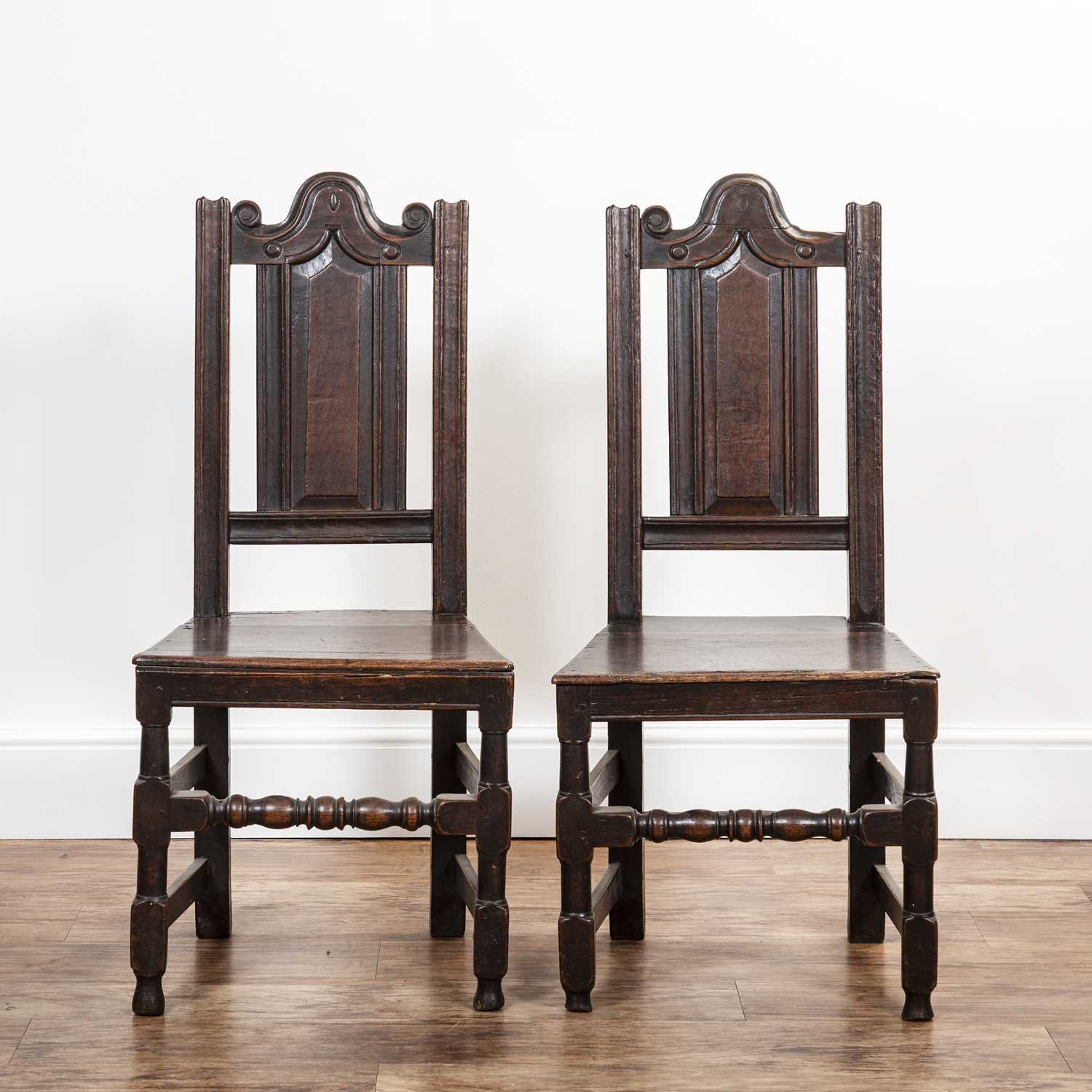 Pair of oak hall chairs Late 17th/early 18th Century, with shaped pediment top rail and turned