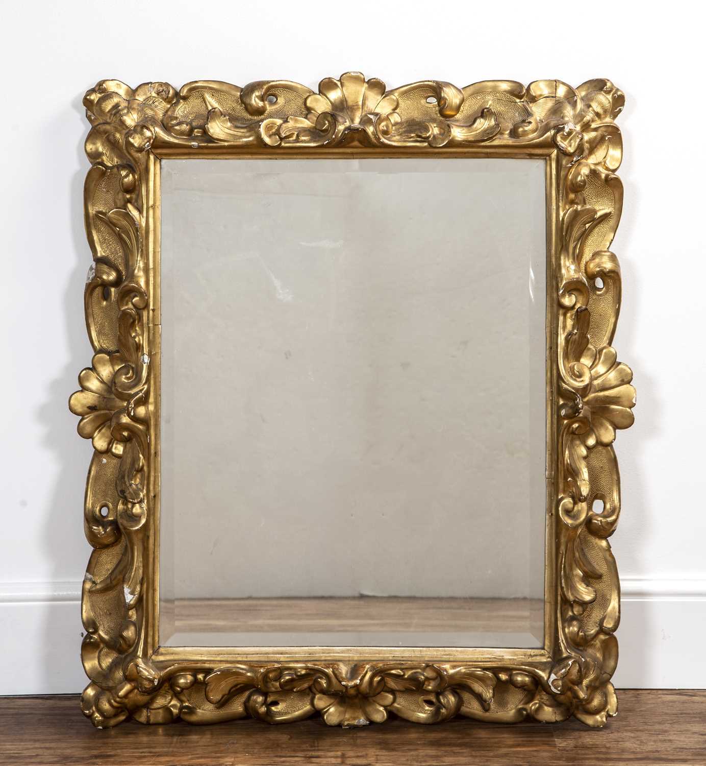 Baroque carved giltwood frame 18th Century, with foliate scroll decoration and later mirror inset