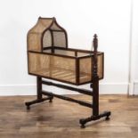 Mahogany and bergere cradle 19th Century, of arched form and with turned stand, cradle 91cm long x