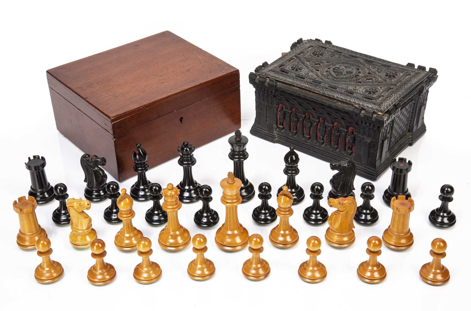 Staunton ebony and weighted boxwood chess set in a mahogany box, king 10cm high, box 21cm wide and a