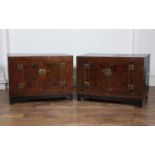 Pair of Chinese lacquer low cupboards each with brass engraved locks, 84cm wide x 55cm deep x 62cm