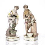 Pair of Derby porcelain figures 19th Century, the lady holding a bird in one hand and a bouquet of