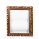 An 18th century French giltwood and gesso frame with acorn foliage upper edge and formal sight,