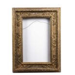 A 16th century Italian giltwood cassetta frame, the centre and corners decorated in relief with