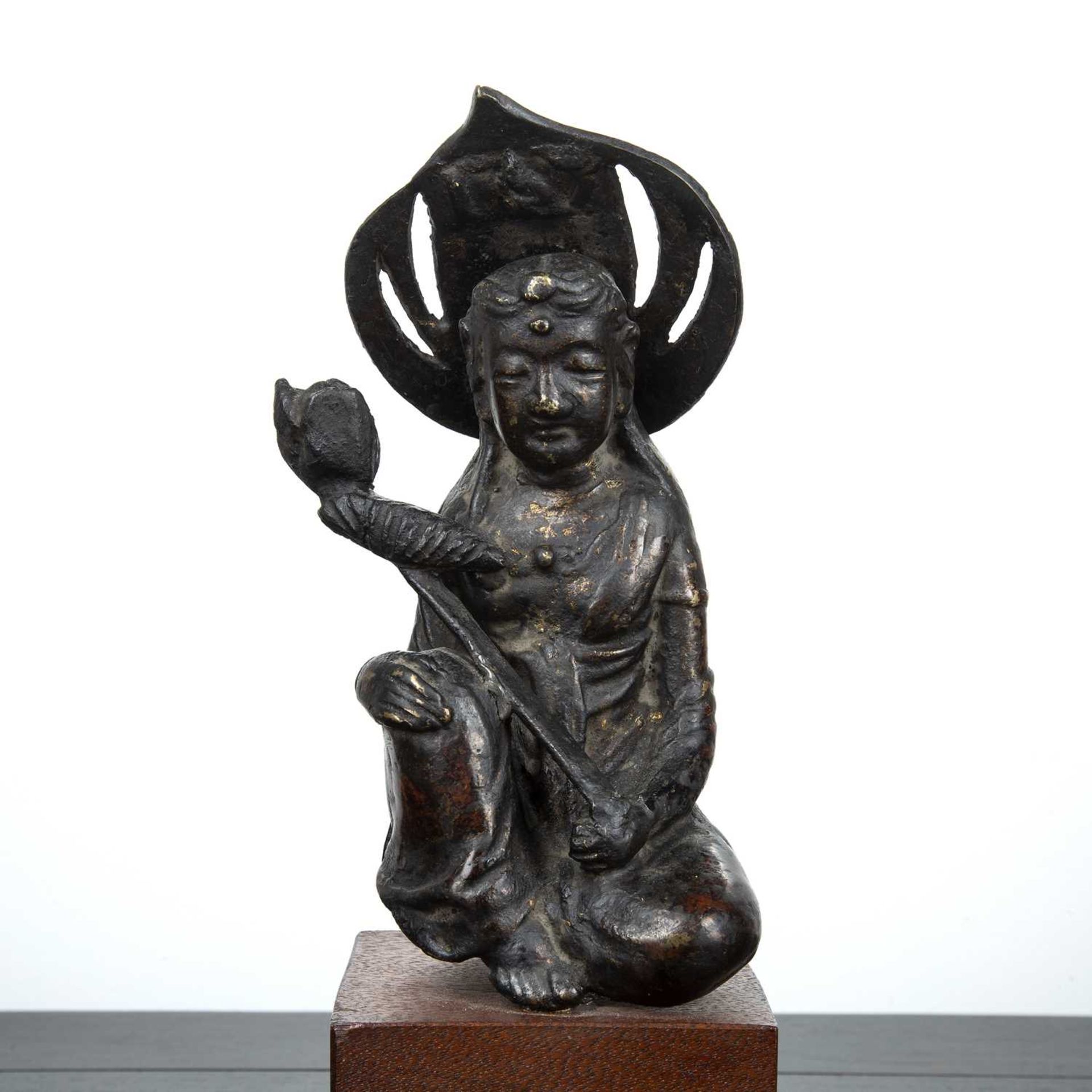 Part gilded bronze Bodhisattva South East Asian, 17th Century the kneeling figure holding a lotus