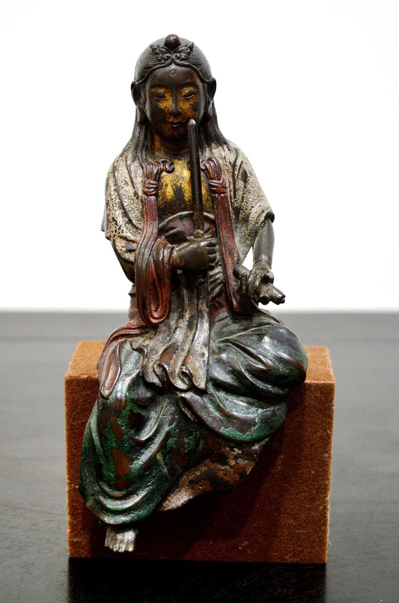 Bronze figure of a seated Boddhisattva Japanese, early Edo holding a sword in her right-hand