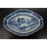 Blue and white shaped dish Chinese, 19th Century decorated with a river scene depicting figures on