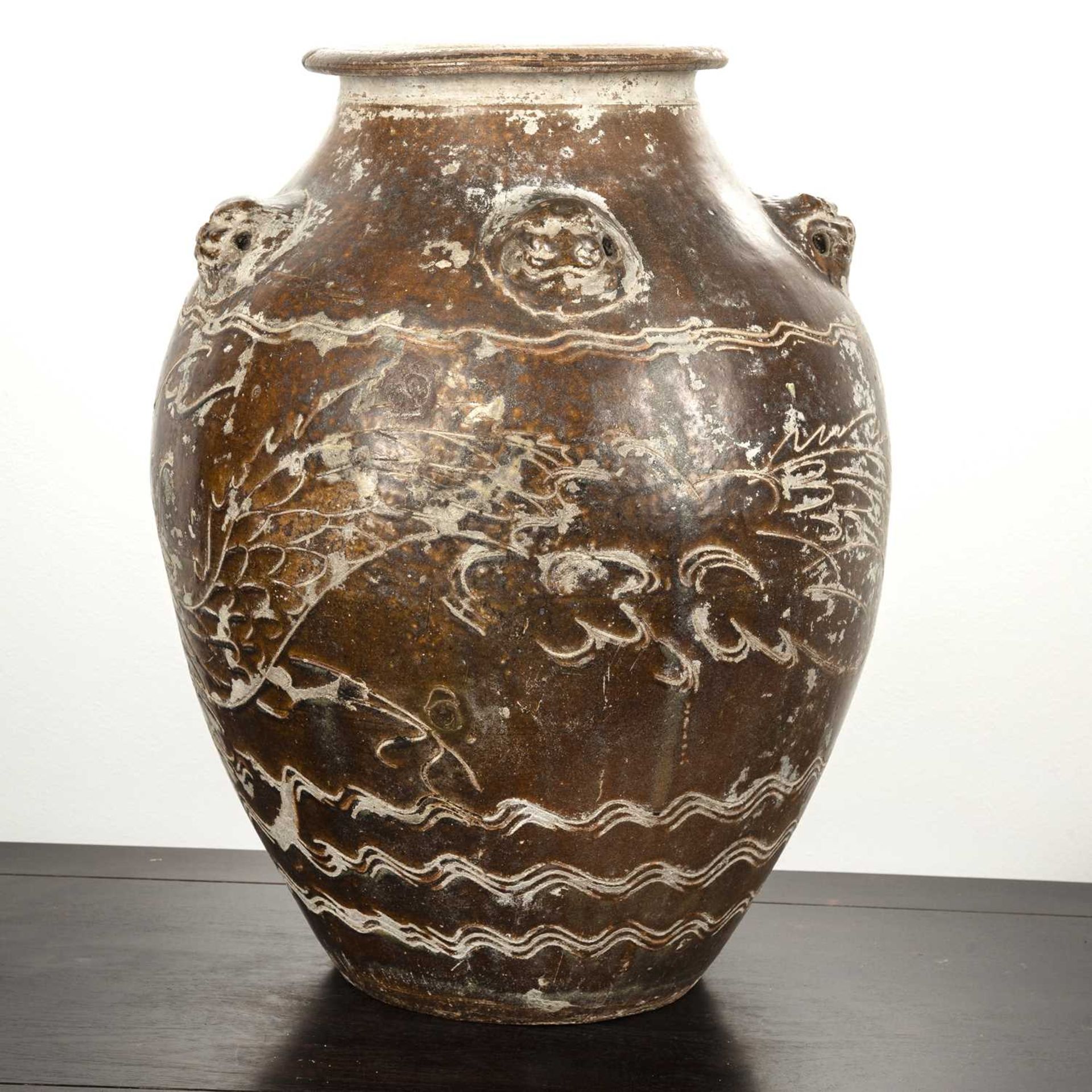 Large treacle glazed storage jar Chinese, 17th/18th Century having five mask handles around the - Image 2 of 5