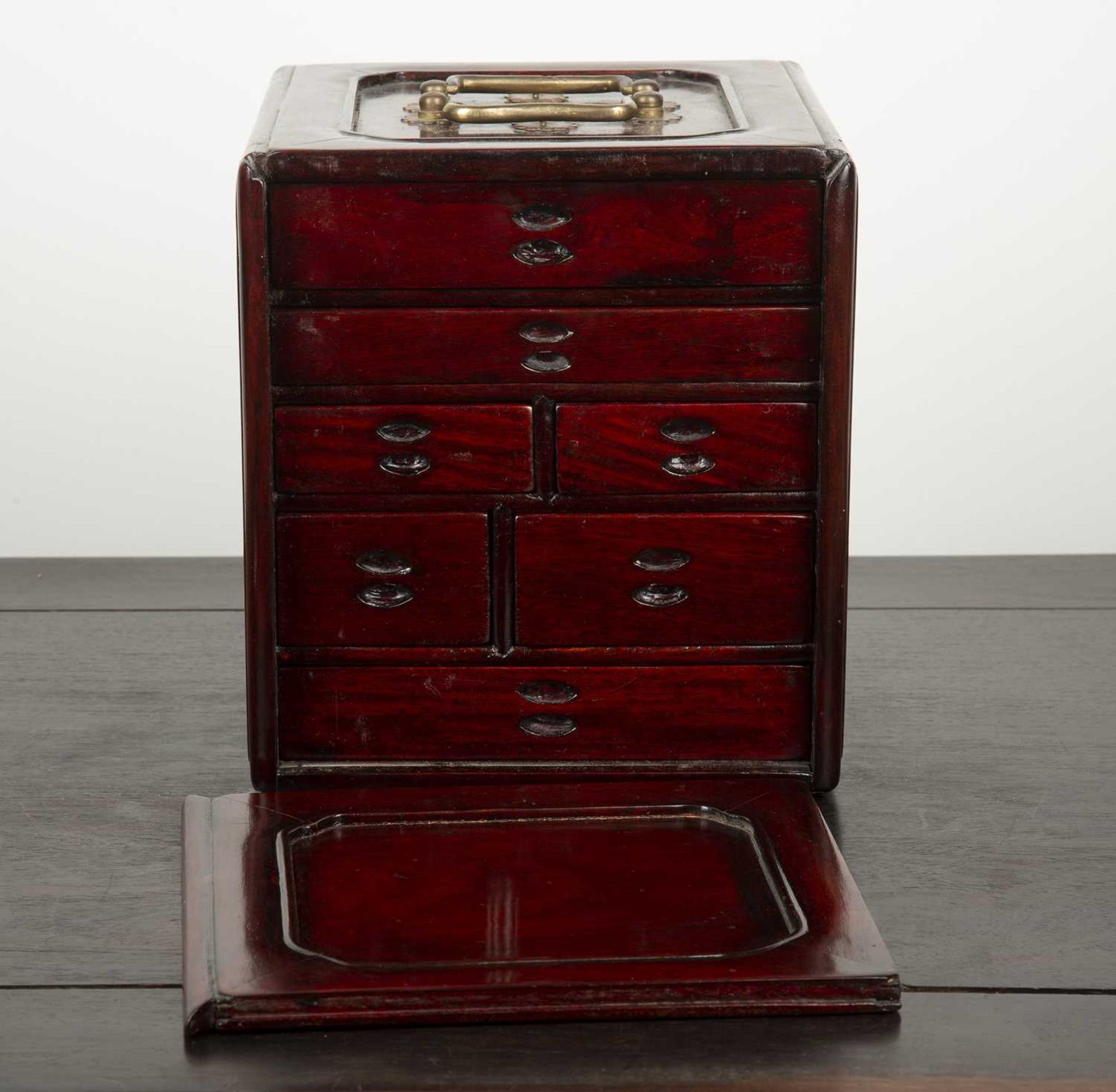Hardwood table top cabinet Chinese fitted with small drawers enclosed by a sliding front, 20cm